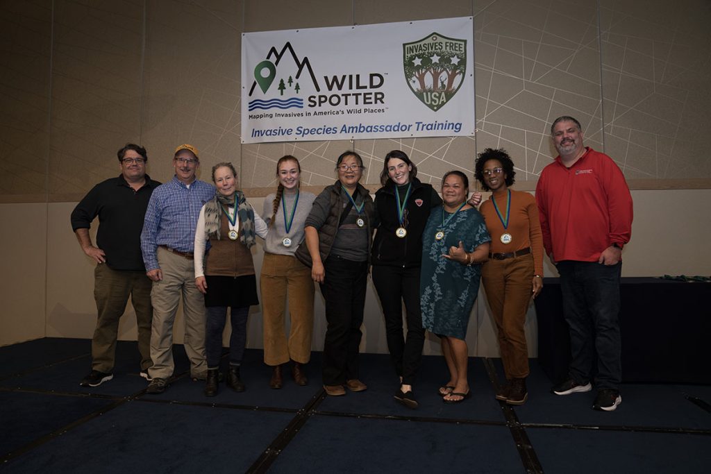 Group of people posed side-by-side for award presentation.