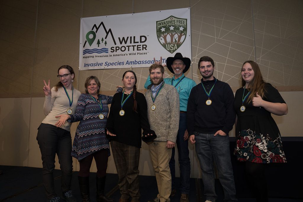 Group of people posed side-by-side for award presentation.